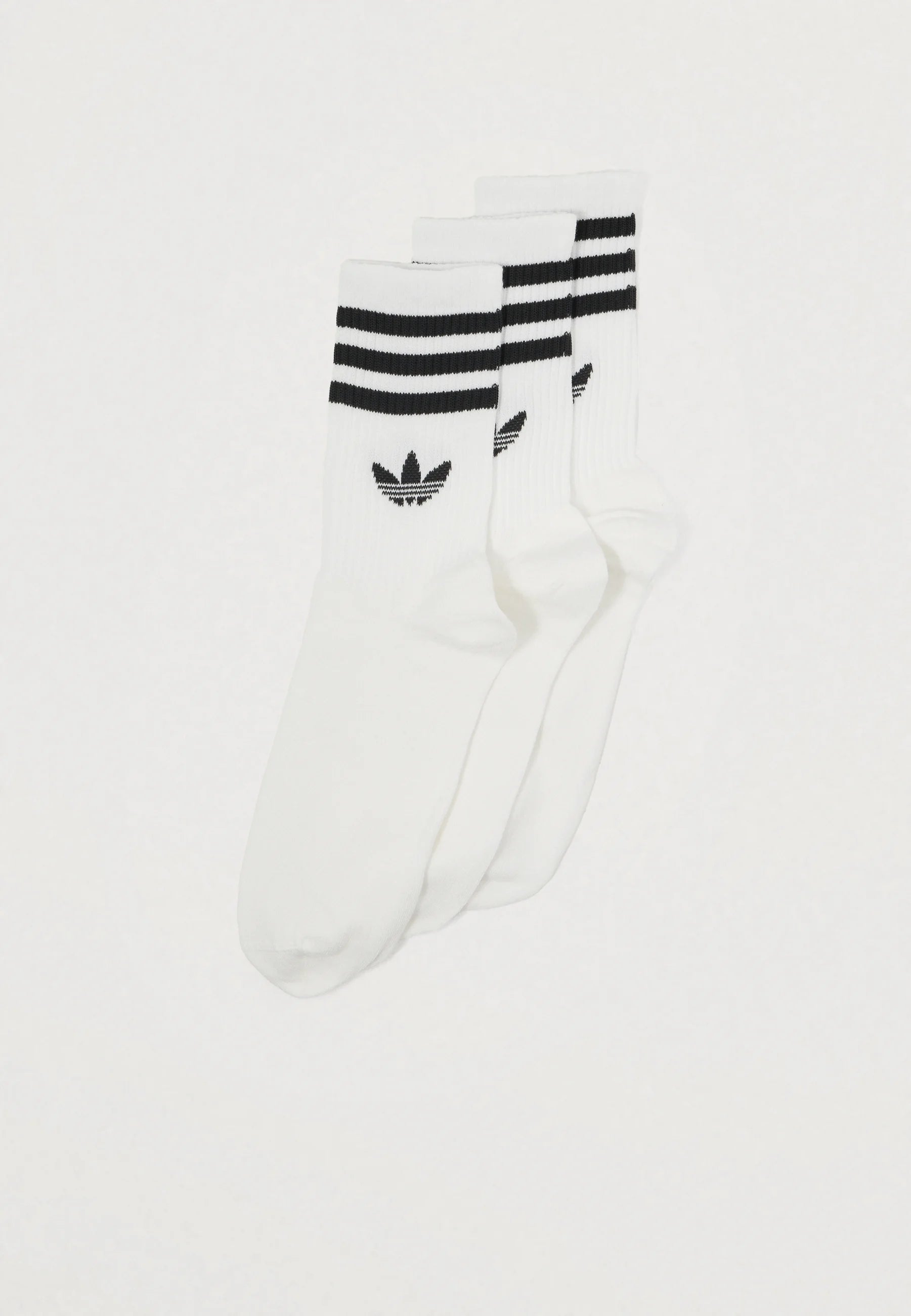 Three pairs of white athletic socks featuring black stripes and a small dark logo. Ribbed texture, ankle length design.